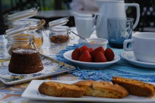 a table topped with plates of bread and strawberries at Agriturismo A casa di Anna in Pellezzano