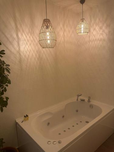 a bathroom with a tub and two pendant lights at On Oda Oludeniz in Oludeniz