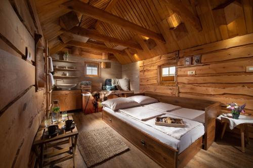 a bedroom with a bed in a wooden cabin at Bio Apartments Trnulja in Ljubljana