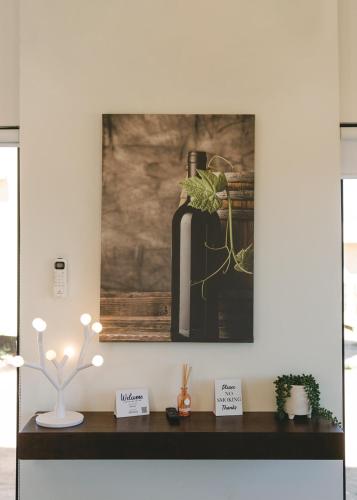 a room with a table with a picture on the wall at Sol del Valle in Valle de Guadalupe