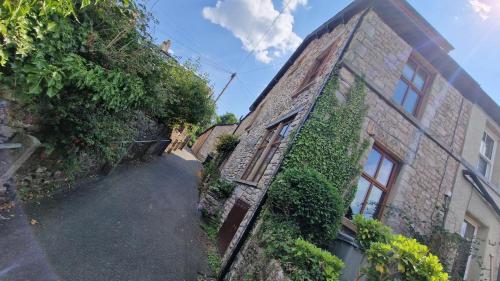 an old brick building with ivy on the side of it at Carr Garth in Arnside