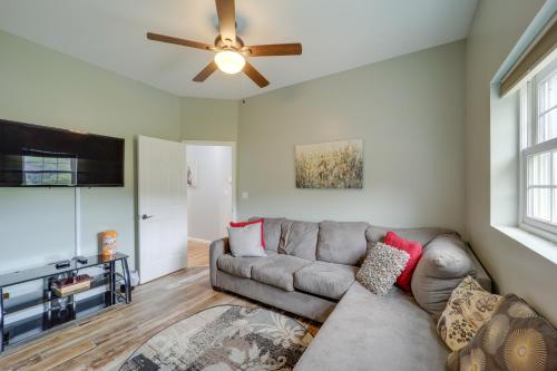 a living room with a couch and a ceiling fan at Classy Home with Hot Tub and Mt Jefferson Views! in West Jefferson