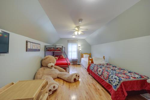 a large teddy bear sitting on the floor in a bedroom at Classy Home with Hot Tub and Mt Jefferson Views! in West Jefferson