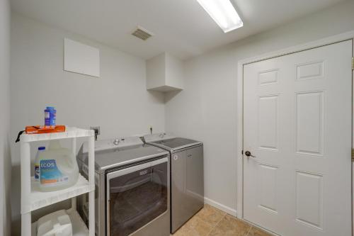a laundry room with a sink and a washing machine at Classy Home with Hot Tub and Mt Jefferson Views! in West Jefferson