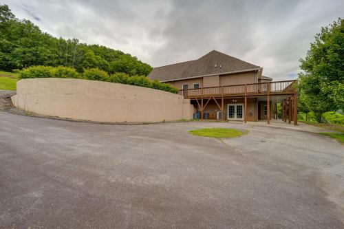 a house with a retaining wall in front of a driveway at Classy Home with Hot Tub and Mt Jefferson Views! in West Jefferson
