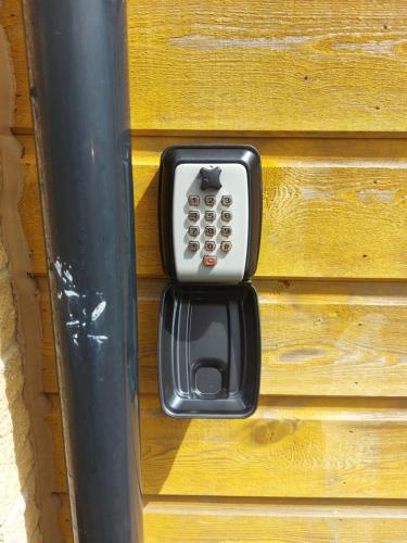 a remote control sticking out of a wooden box at The Mews in Inverness