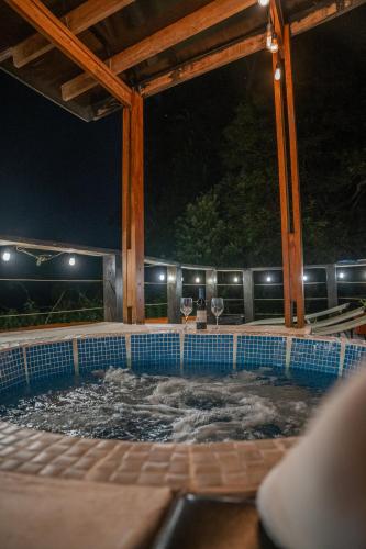 a swimming pool at night with the lights on at Vistas del Conde in Heredia
