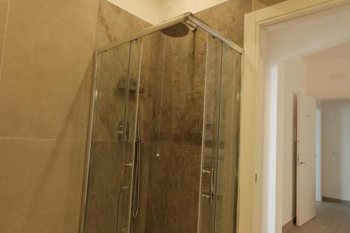 a shower with a glass door in a bathroom at Like Lake Bisentina in Marta