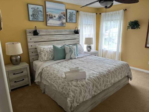 a bedroom with a large bed and a window at Villa Madiera 6 bedroom huge house in Kissimmee