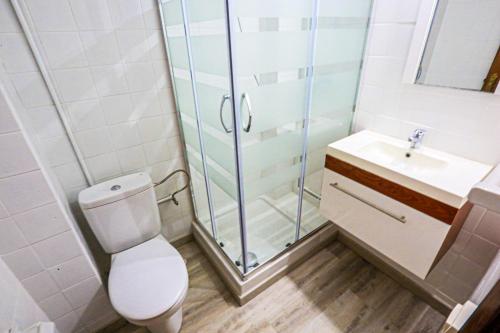 a bathroom with a shower and a toilet and a sink at Bello Horizonte ONLY FAMILIES in Salou