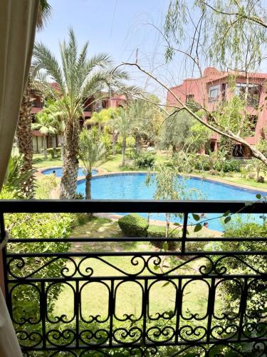 a view of a swimming pool from a balcony at Dar Marrakech in Marrakech