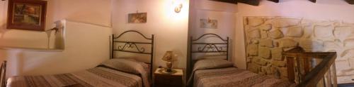 a bedroom with two beds in a room at Anticu Dammusu in Scicli