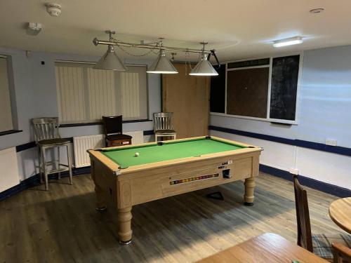 a billiard room with a pool table in it at The Bull Hotel in Valley