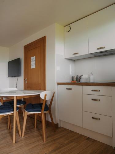 a kitchen with a table and two chairs and a counter at Wideta in Smerek
