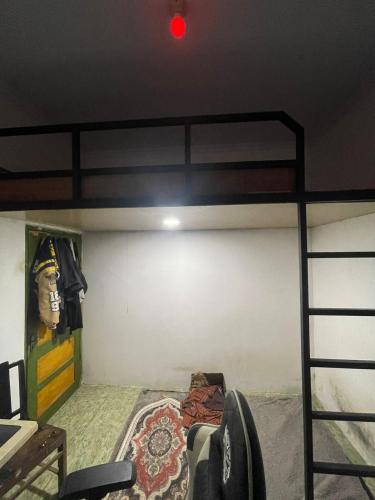a bedroom with a bunk bed with a red light at Rick Homestay in Pundung