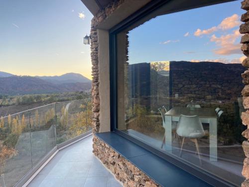 a room with a window with a table and a view at Casa Rural Piedra de la Torre in Riópar