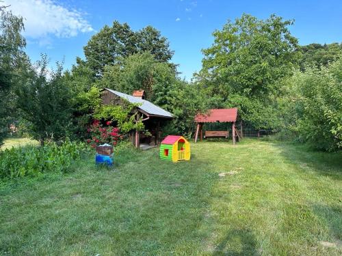 a yard with a house and a play structure at Cristian in Dejani
