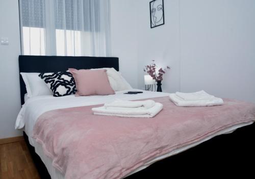 a bedroom with a bed with two towels on it at Apartman Dunjic in Vrnjačka Banja