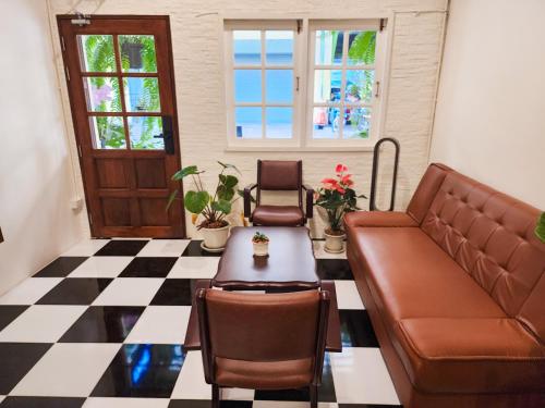 a living room with a couch and a table at Noir Cafe And Hostel Chinatown Bangkok in Chinatown