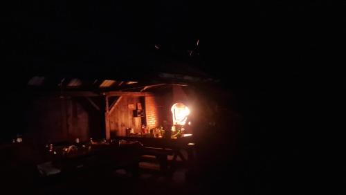 Habitación oscura con una mesa con luz por la noche en Cristian, en Dejani