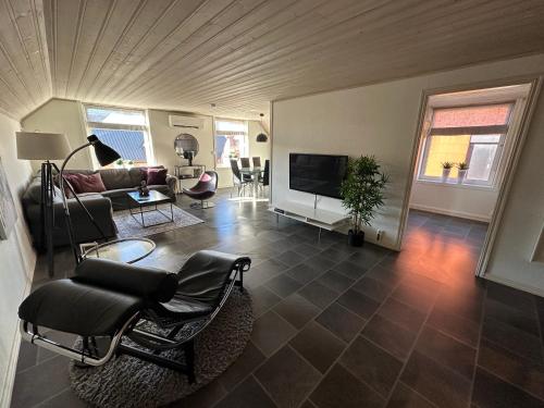 a living room with a couch and a tv at Kirkegata 7 in Sarpsborg