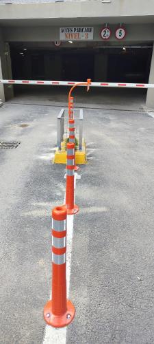 three orange and white poles in a parking lot at STUDIO JACUZZI BELLE VIEW SINAIA-free parking in Sinaia