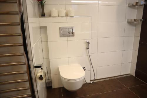 a small bathroom with a toilet and a shower at Landhaus-Appartements Warraich in Schladming