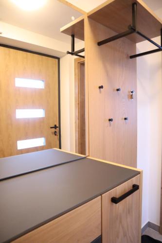 a kitchen with a counter top and wooden doors at Landhaus-Appartements Warraich in Schladming