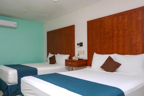Кровать или кровати в номере Terracaribe Hotel Boutique