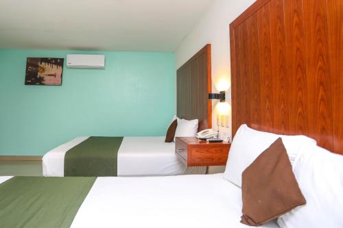 Кровать или кровати в номере Terracaribe Hotel Boutique