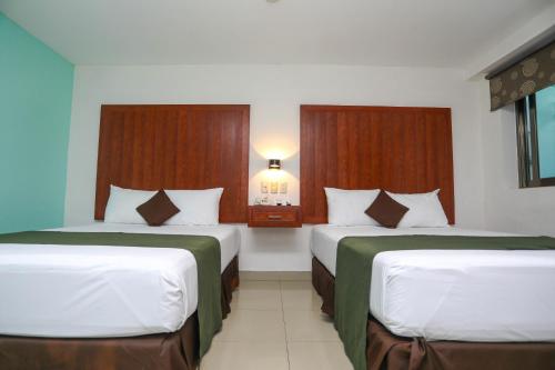Кровать или кровати в номере Terracaribe Hotel Boutique