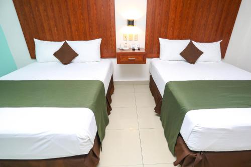 Кровать или кровати в номере Terracaribe Hotel Boutique