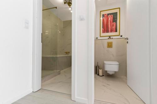 a white bathroom with a shower and a toilet at LAM Pink - JACUZZI - AC - PS4 in Bratislava