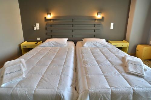Säng eller sängar i ett rum på Leonidaion Guesthouse