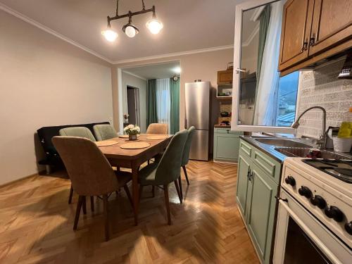 a kitchen with a table and chairs in a kitchen at Happy Holidays in Borjomi