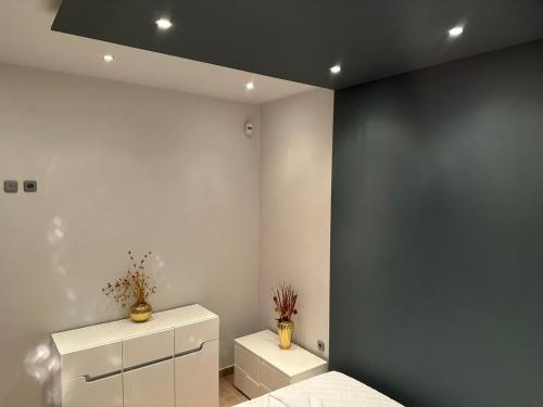 a room with two white cabinets and a blue wall at Villa Marmari 1 in Marmarion