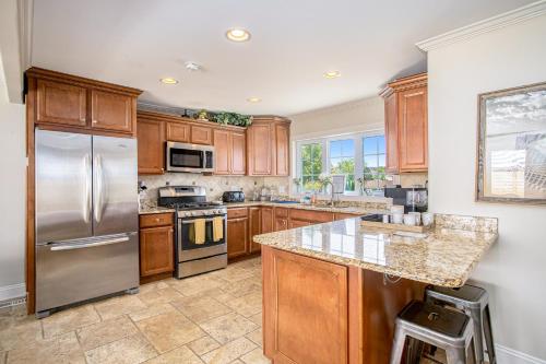 a kitchen with wooden cabinets and a stainless steel refrigerator at Surf's Up in New Buffalo