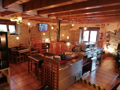 a kitchen with a counter and tables in a restaurant at Lo Paller de Roc in Montescladó