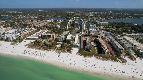 an aerial view of a resort on the beach at 6415 Midnight Pass #307 in Siesta Key