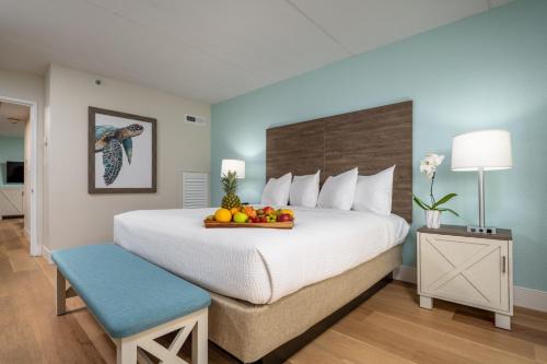 a hotel room with a bed with a tray of fruit on it at Princess Royale Oceanfront Resort in Ocean City