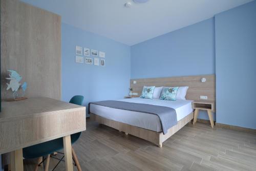 a bedroom with a bed and a desk and a bed sidx sidx sidx at Niel Holiday Apartments, Panel Hospitality Homes & Villas in Leptokaria