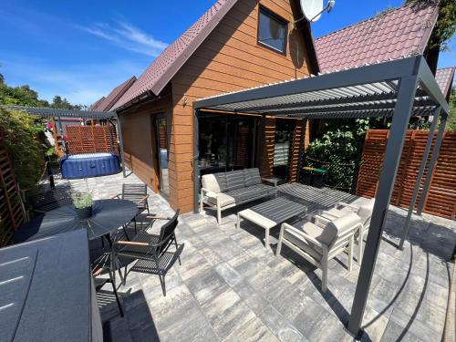 a patio with a table and chairs and a umbrella at GooseHaus in Gąski