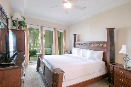 a bedroom with a large bed and a television at Legacy I 102 in Gulfport