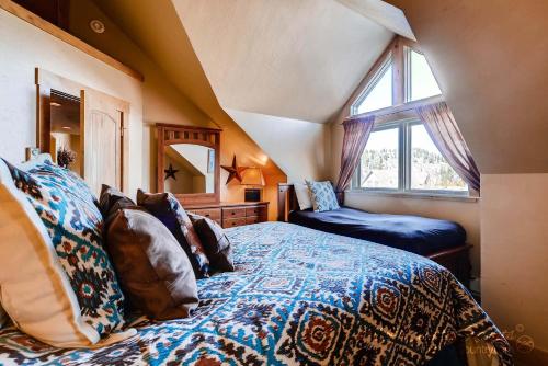 a bedroom with a large bed and a window at True Downtown Location on Main St - 150 Steps to Gondola, Private Hot Tub, DOG FRIENDLY! SCC3 in Breckenridge
