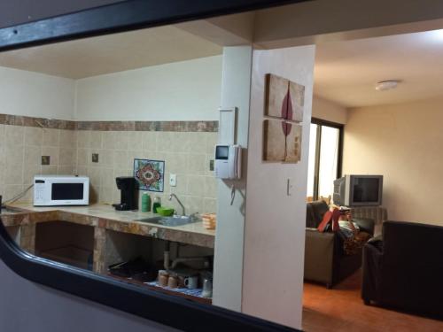 a view of a kitchen and a living room at Casa Entera Gran Descanso - Wifi in Apizaco