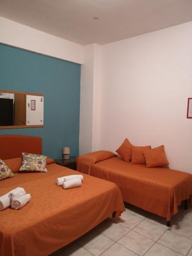 a bedroom with two beds with towels on them at B&B Casa Valeria in Catania