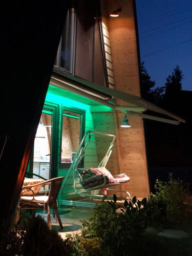a house with a green stair case and two chairs at Happy House Bungalov Three-Room SPA JAKUZİ Lake view in Sapanca B2 in Sapanca