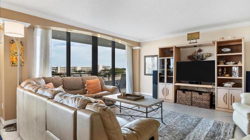 a living room with a couch and a tv at 6415 Midnight Pass #611 in Siesta Key