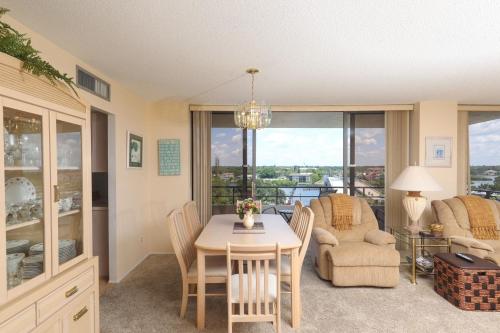 a kitchen and dining room with a table and chairs at 6415 Midnight Road #709 in Siesta Key