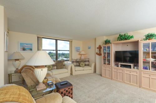 a living room filled with furniture and a flat screen tv at 6415 Midnight Road #709 in Siesta Key